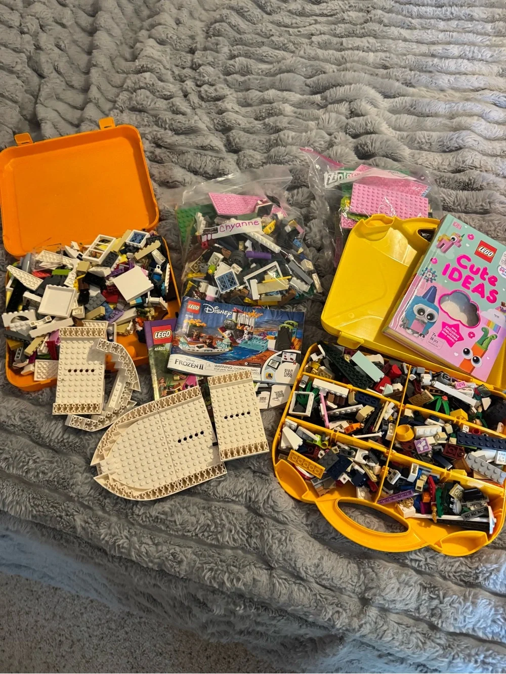 Lego Yellow and Orange Carry Cases filled with Lego bricks and a bag of boards